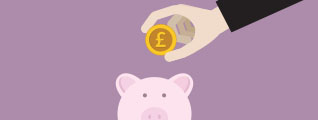 Coin about to be dropped into piggy bank