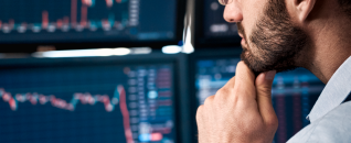 Man looking at trader screens