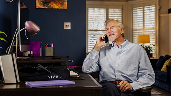 Man on phone in home office